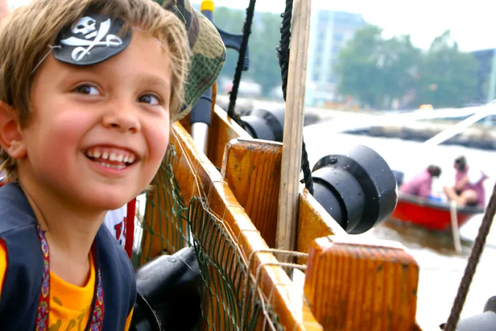 a little boy is smiling at the camera