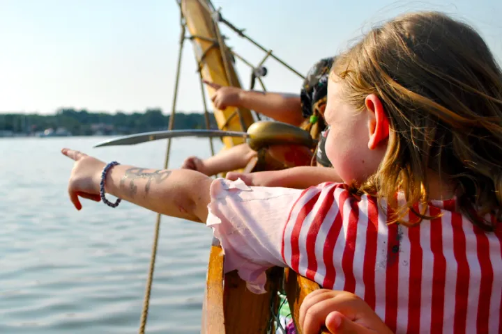 a person standing next to a body of water